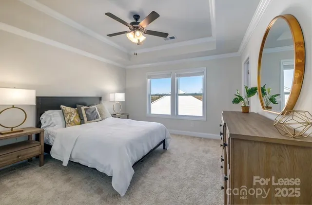 a spacious bedroom with a bed and window