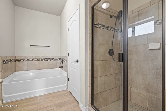 a bathroom with a tub and shower
