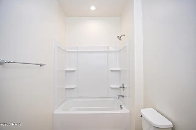 a large kitchen with kitchen island a large counter top stainless steel appliances and a window