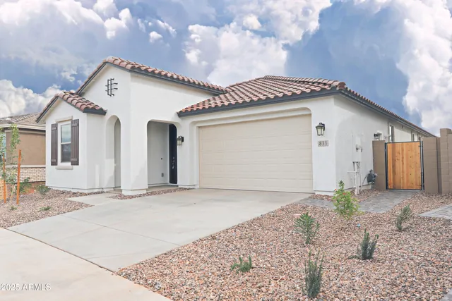 a view of a house with a dry space in front and yard