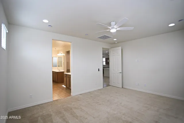 a spacious bathroom with a double vanity sink and mirror with shower