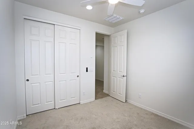 an empty room with windows and closet