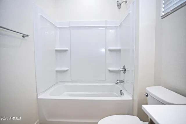 a bathroom with a bathtub and toilet