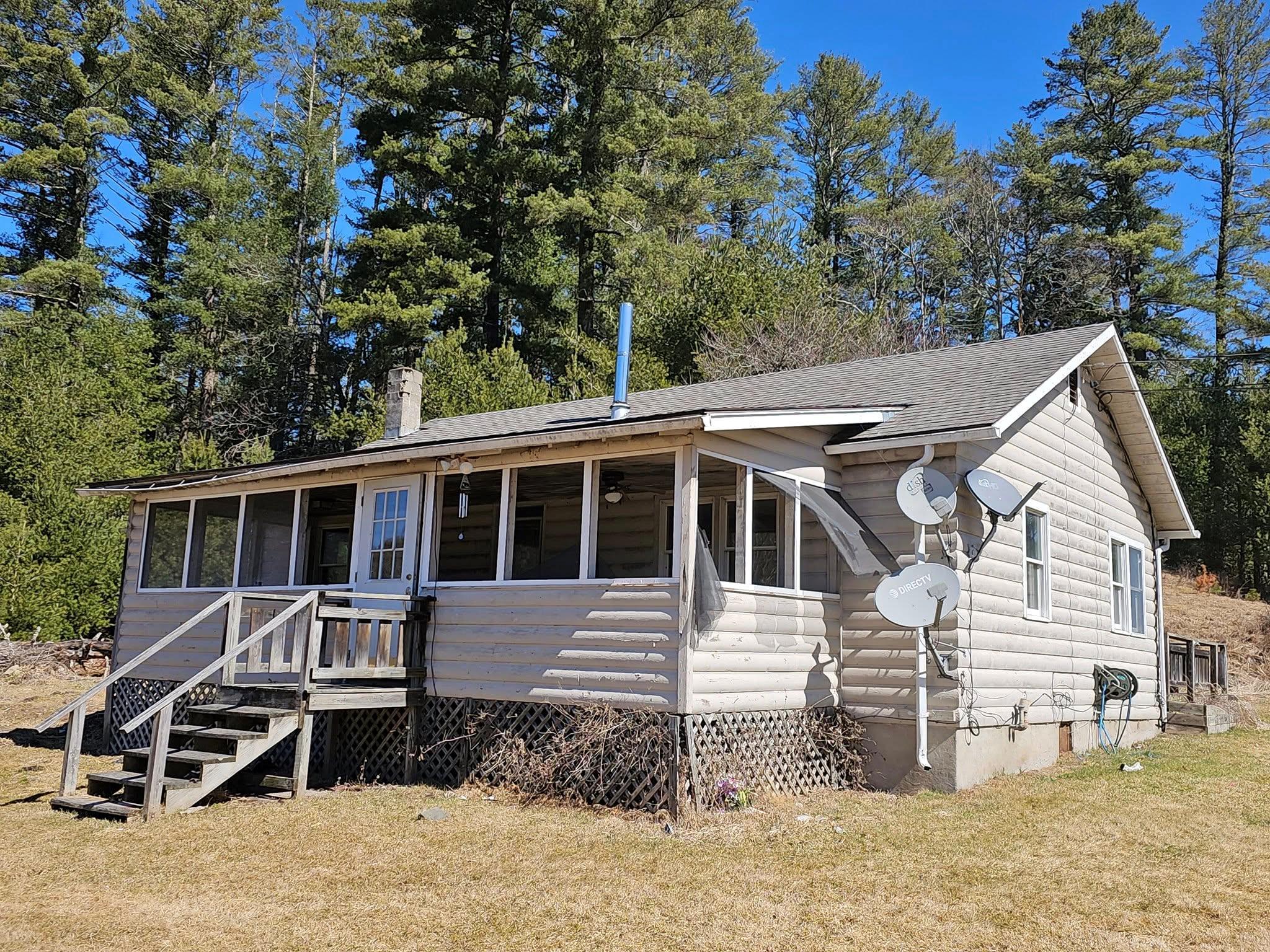 a front view of a house with a yard and balcony