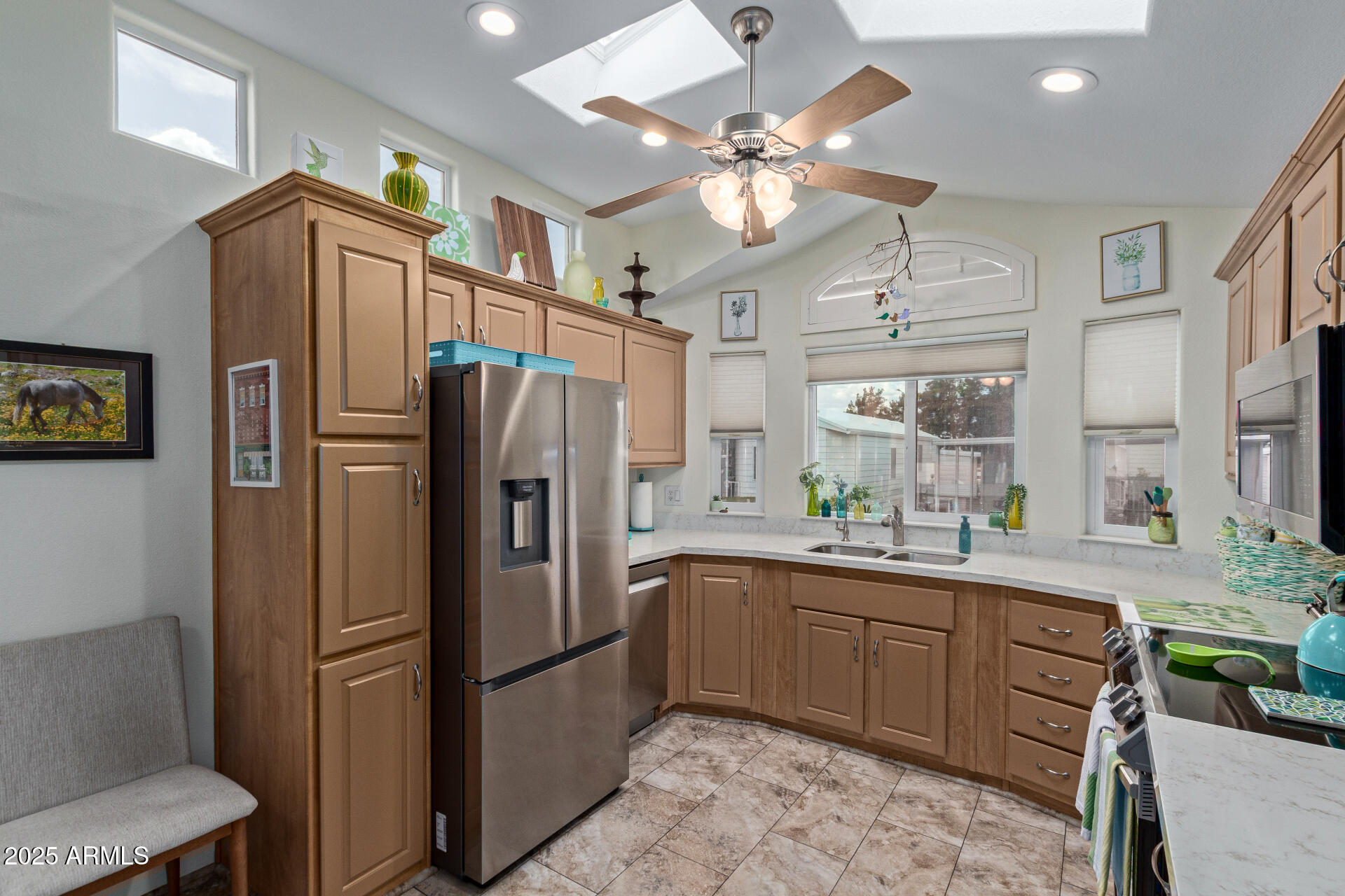 111 South Greenfield Road, Unit 449 Mesa, AZ 85206 - Photo 12 of 34 a kitchen with stainless steel appliances a refrigerator sink and stove