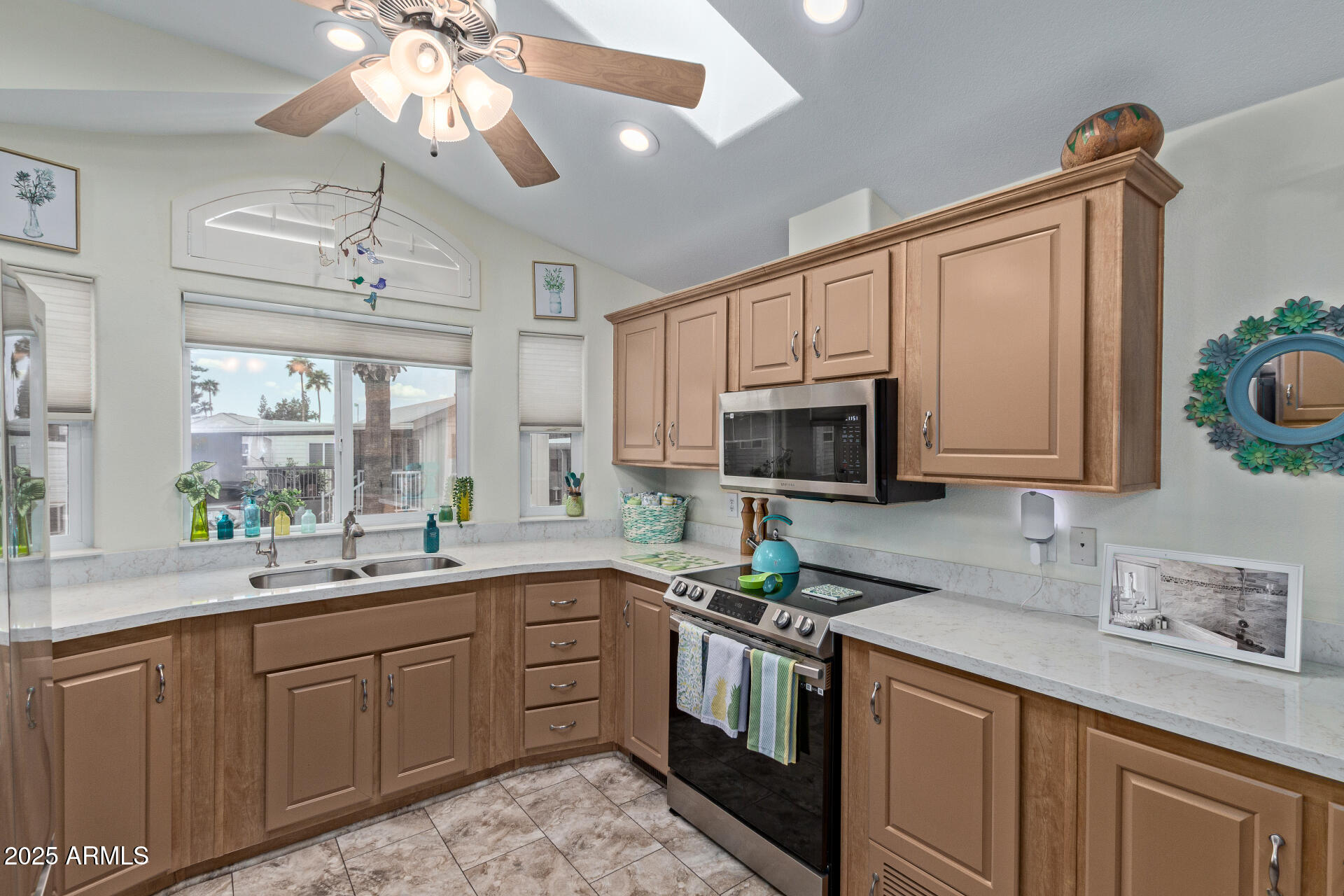 111 South Greenfield Road, Unit 449 Mesa, AZ 85206 - Photo 13 of 34 a kitchen with a sink a stove and microwave