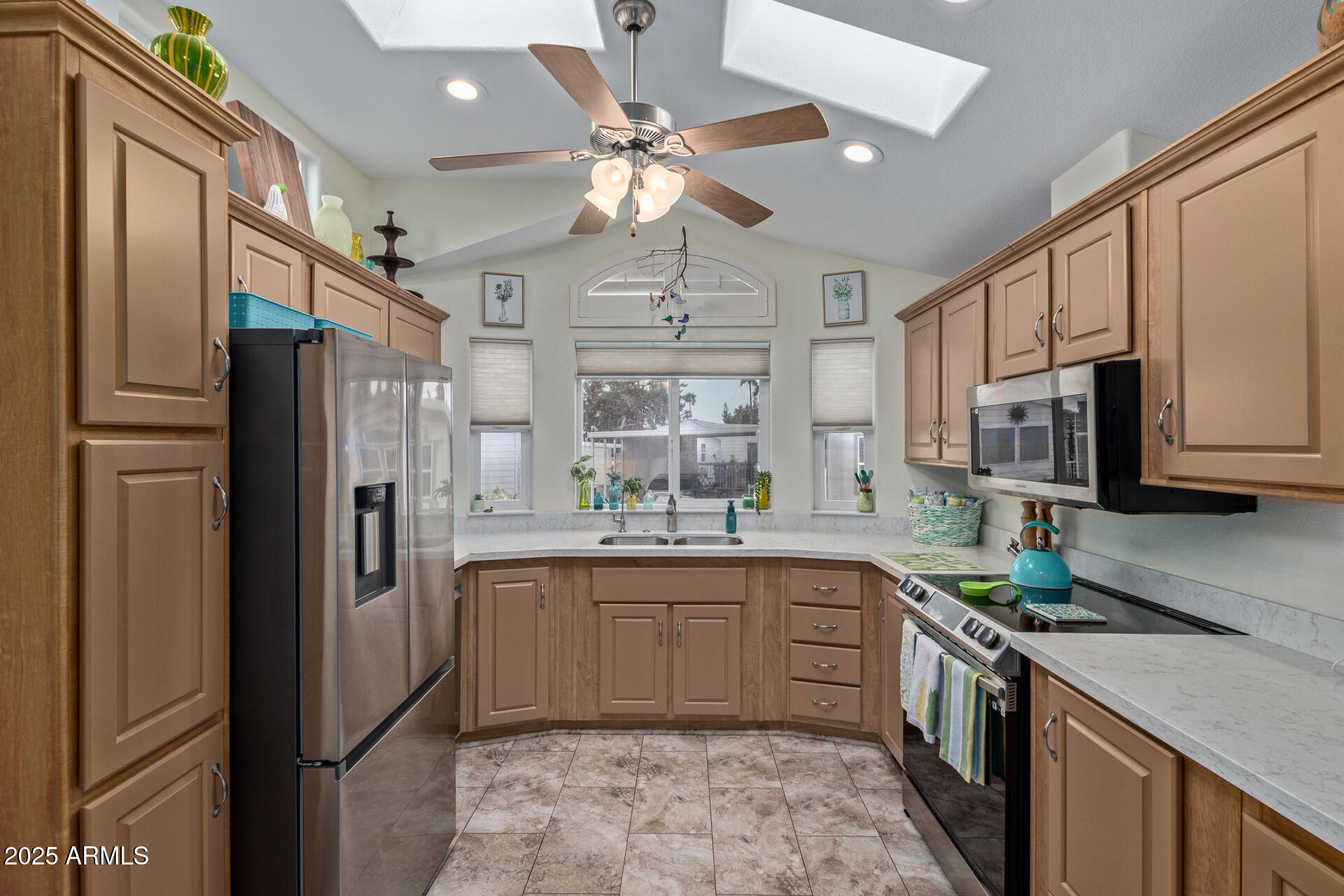 111 South Greenfield Road, Unit 449 Mesa, AZ 85206 - Photo 14 of 34 a kitchen with stainless steel appliances a sink stove and refrigerator