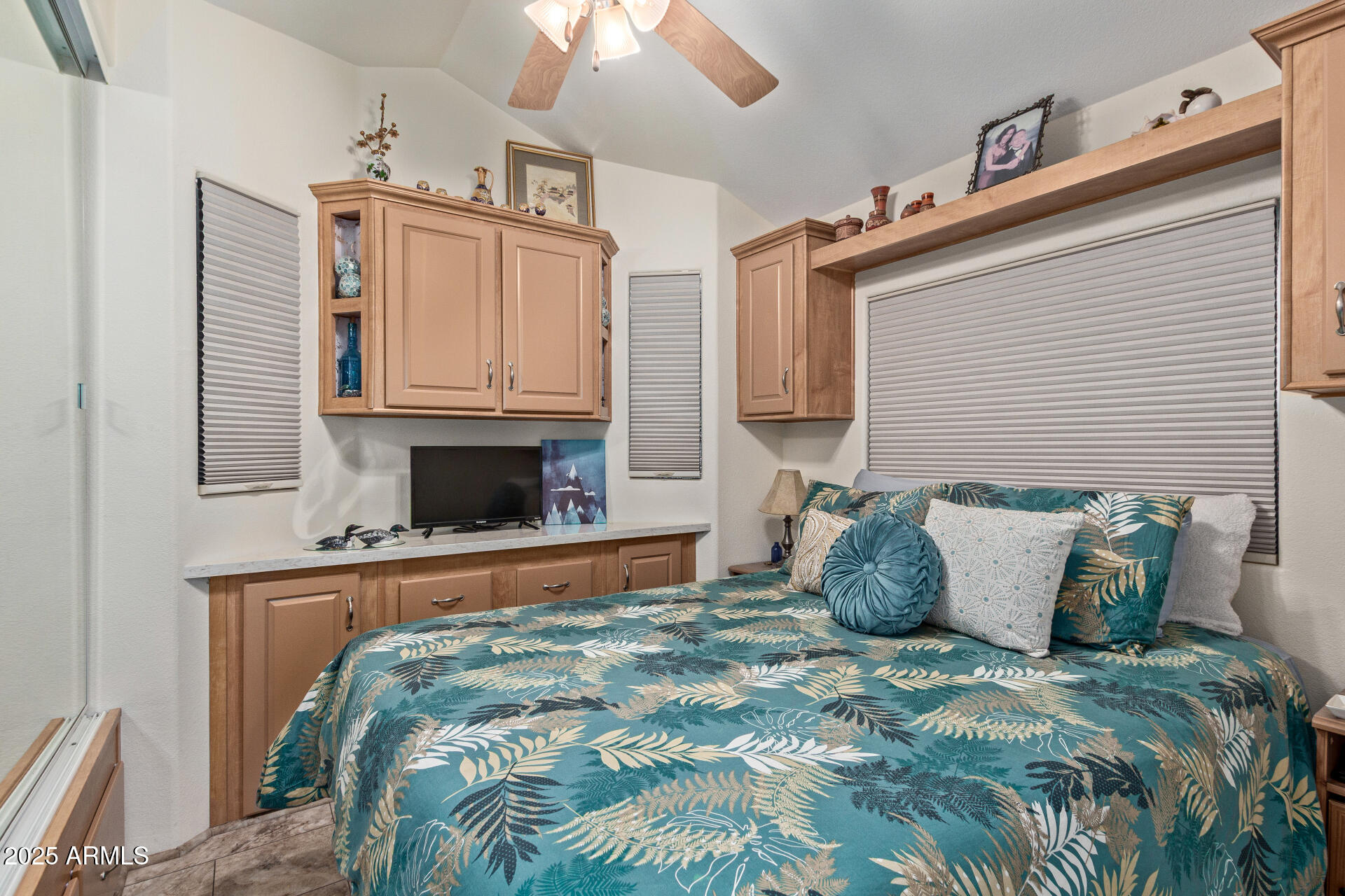 111 South Greenfield Road, Unit 449 Mesa, AZ 85206 - Photo 16 of 34 a bed sitting in a bedroom next to a fireplace