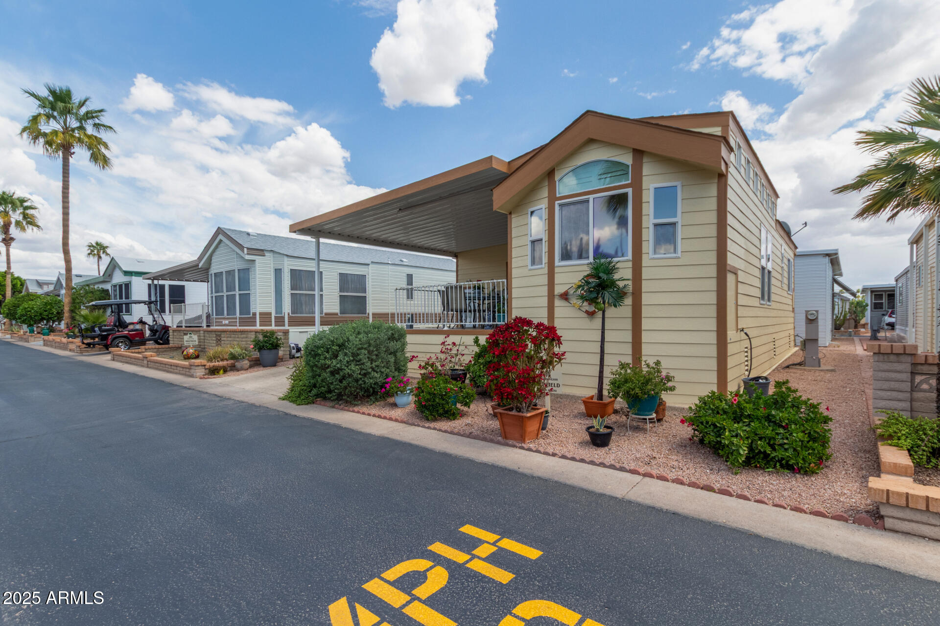 111 South Greenfield Road, Unit 449 Mesa, AZ 85206 - Photo 3 of 34 a front view of a house with a yard and potted plants