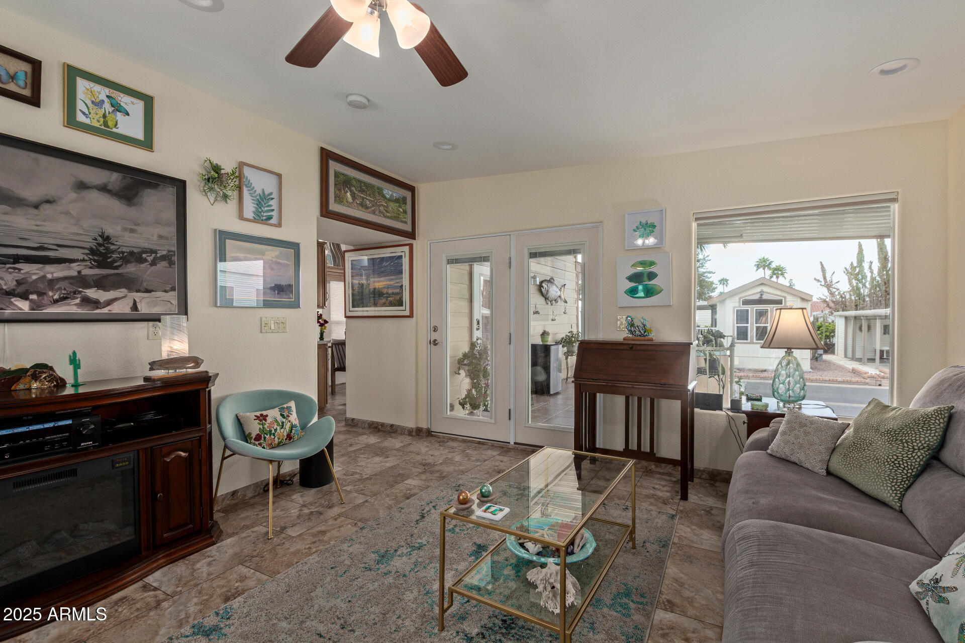 111 South Greenfield Road, Unit 449 Mesa, AZ 85206 - Photo 9 of 34 a living room with furniture a chandelier and a window