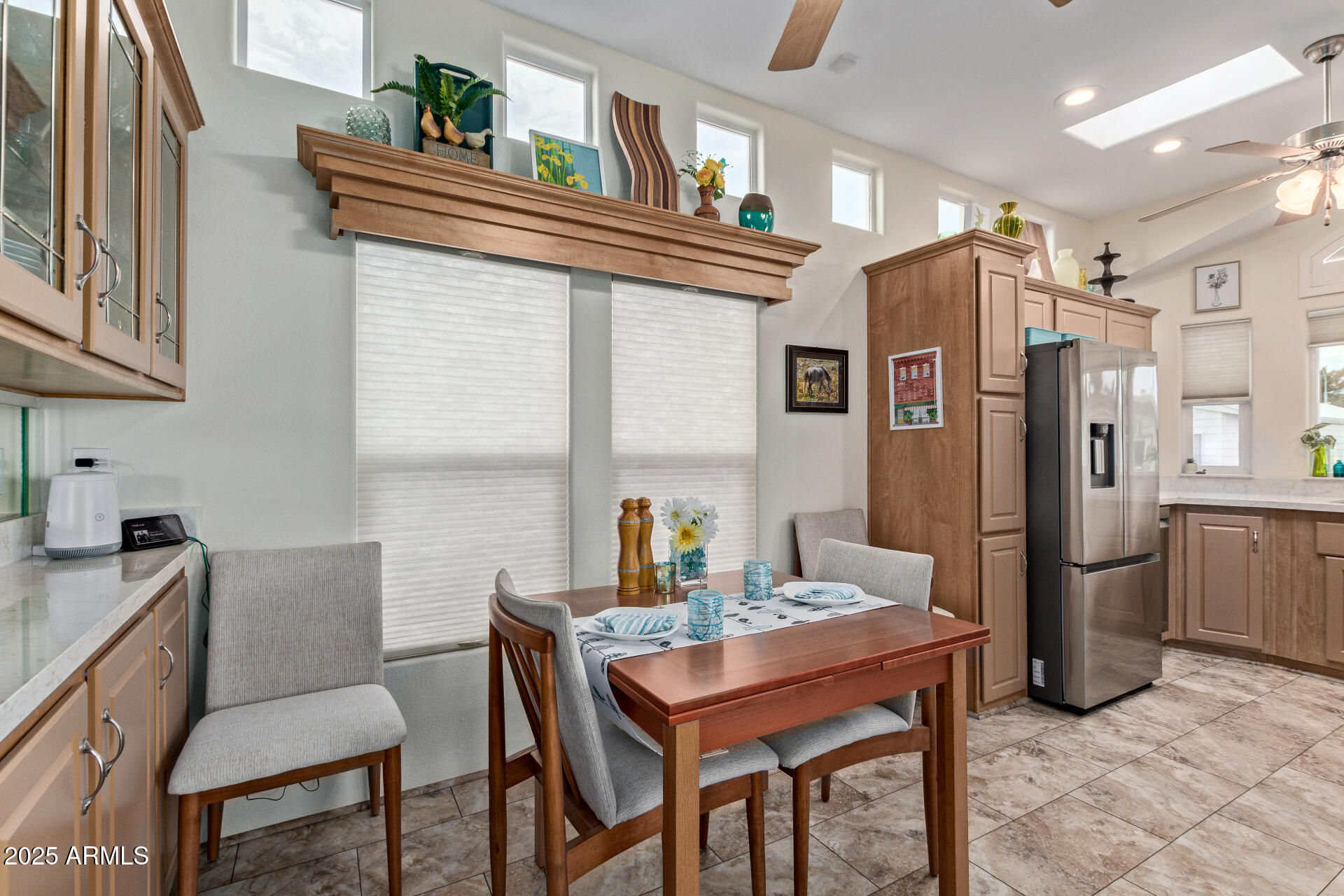 111 South Greenfield Road, Unit 449 Mesa, AZ 85206 - Photo 10 of 34 a kitchen with stainless steel appliances granite countertop a dining table chairs refrigerator and sink
