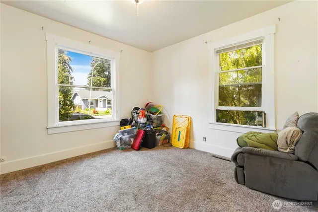 a view of a livingroom with furniture and windows