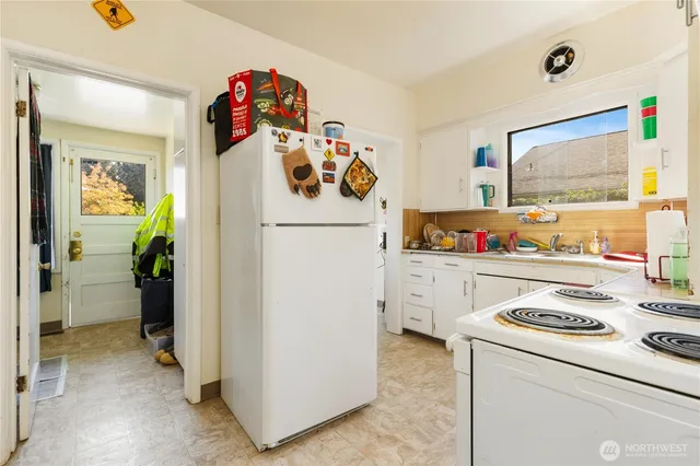 a kitchen with a refrigerator and washer
