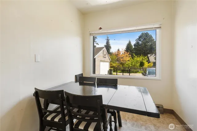 a view of a dining room with furniture and window