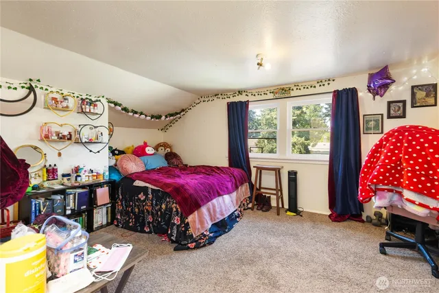 a bedroom with bed and a window