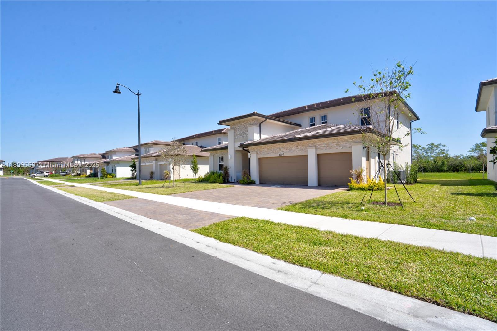 4390 Southwest 122nd Terrace Davie, FL 33330 - Photo 15 of 65 a front view of a house with a yard