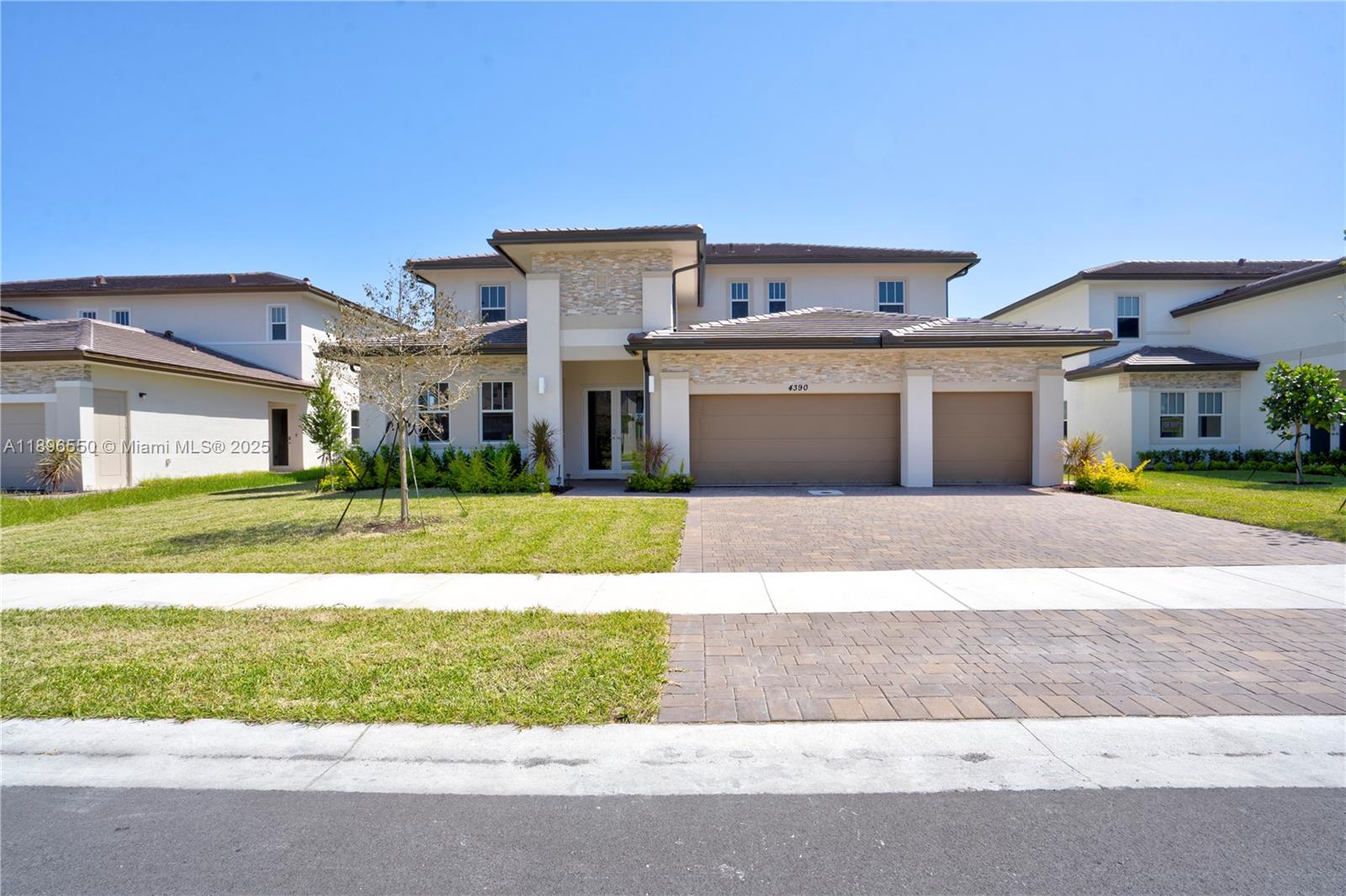 4390 Southwest 122nd Terrace Davie, FL 33330 - Photo 16 of 65 a front view of a house with a yard