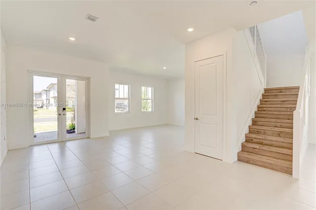 a large white kitchen with a large window