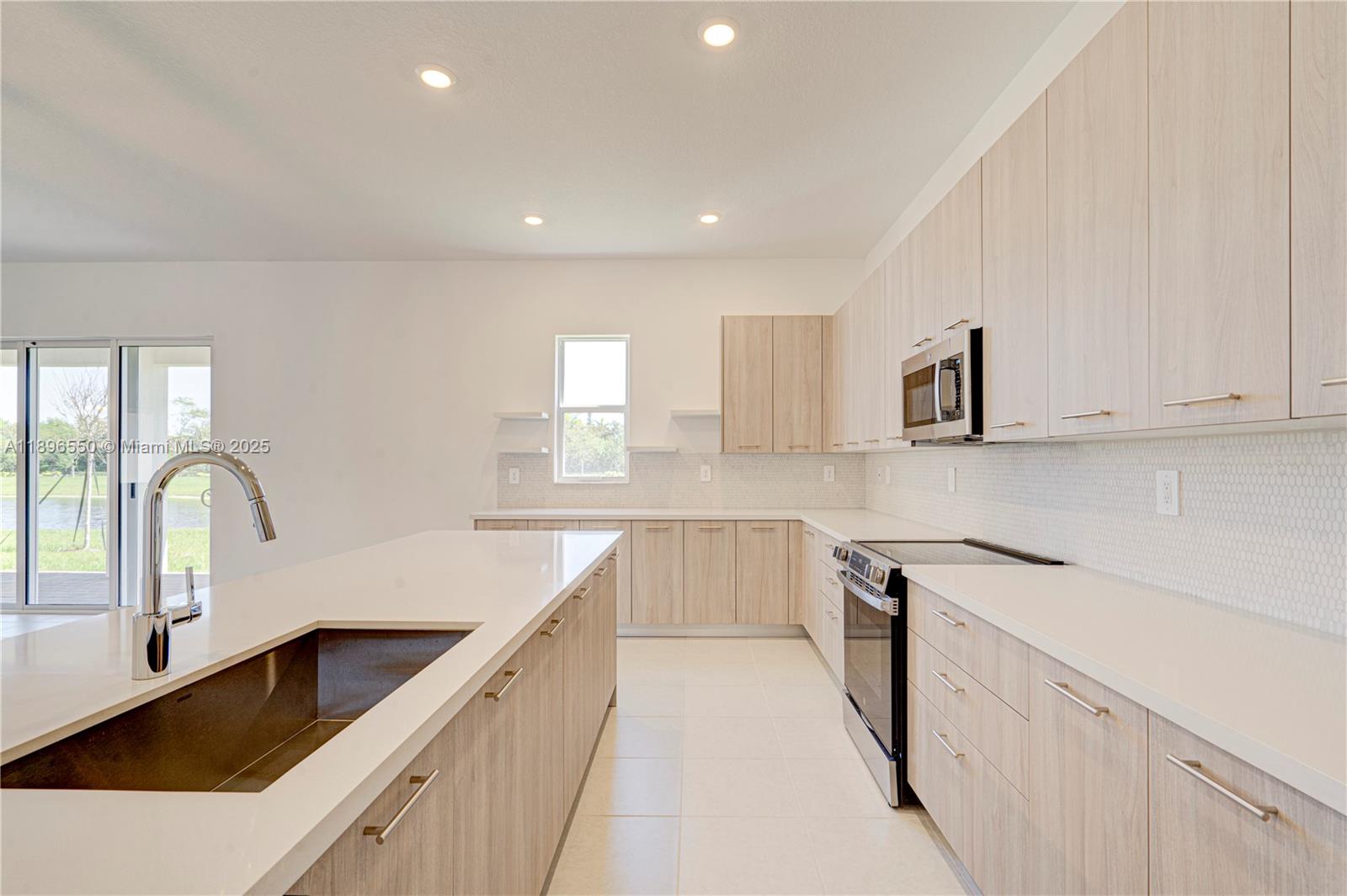 4390 Southwest 122nd Terrace Davie, FL 33330 - Photo 33 of 65 a kitchen with granite countertop white cabinets and sink