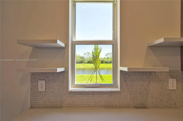 a view of kitchen with sink and refrigerator