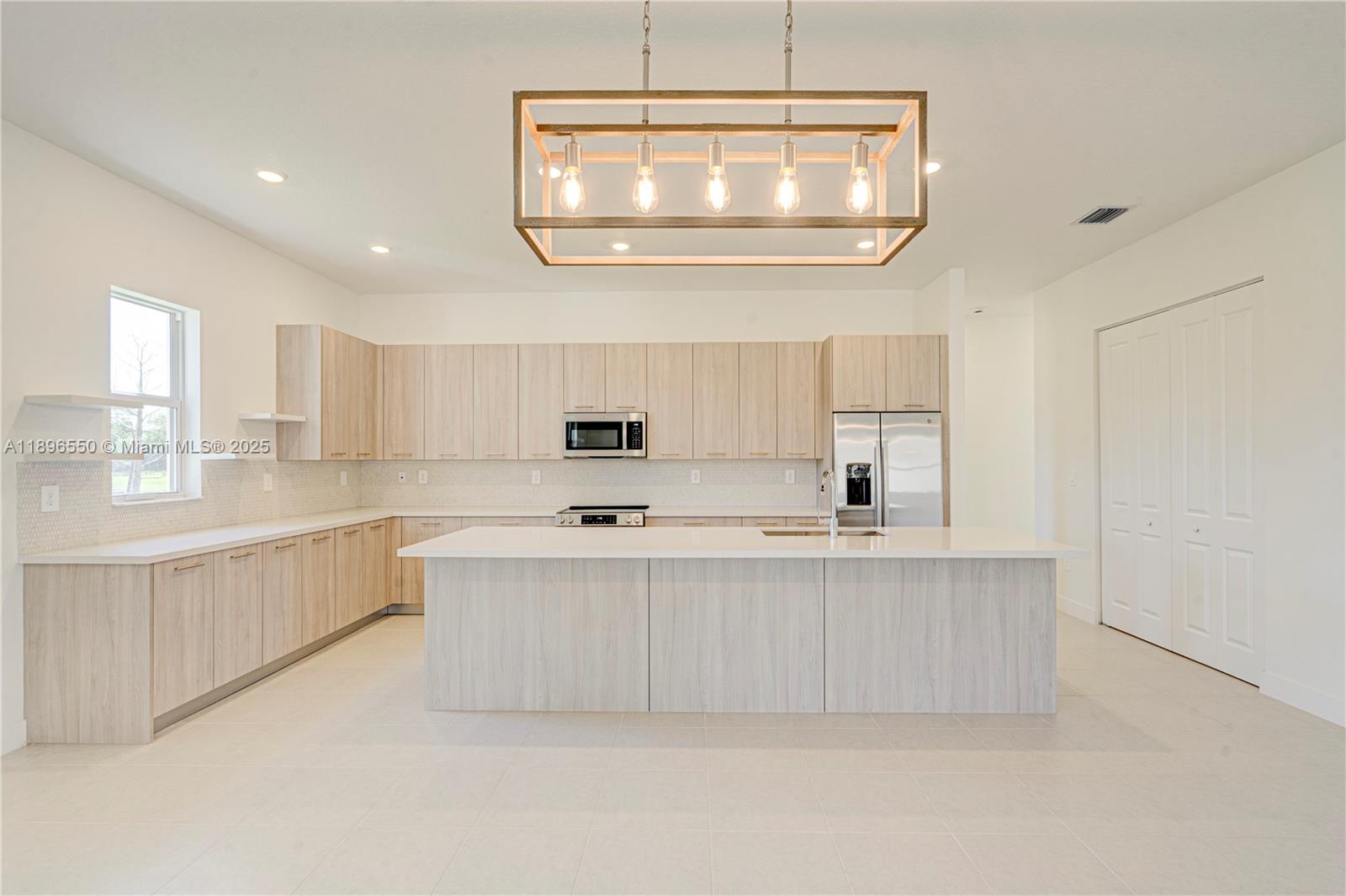 4390 Southwest 122nd Terrace Davie, FL 33330 - Photo 38 of 65 a large white kitchen with a large window
