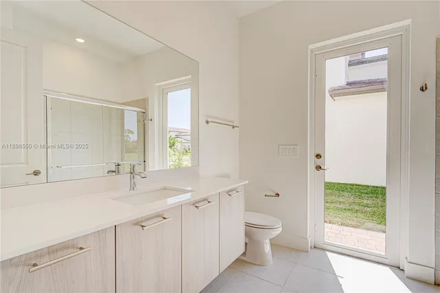 a spacious bathroom with a shower sink and mirror