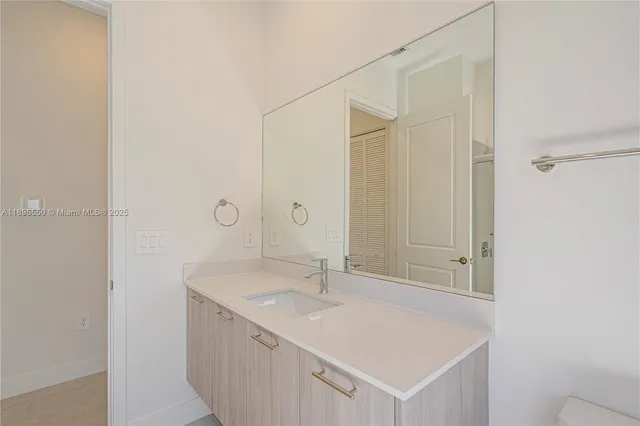 a bathroom with a shower sink and mirror