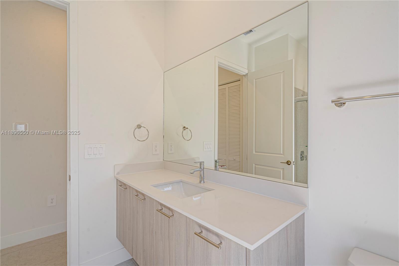 4390 Southwest 122nd Terrace Davie, FL 33330 - Photo 42 of 65 a bathroom with a sink a vanity and a mirror