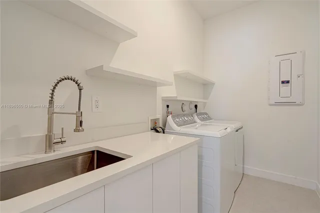a large white bathroom with a double vanity sink a mirror and a bathtub