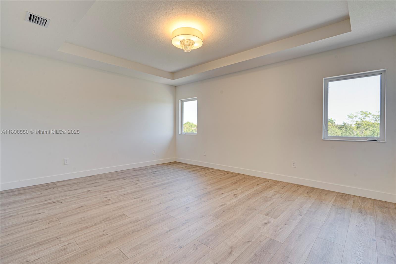 4390 Southwest 122nd Terrace Davie, FL 33330 - Photo 52 of 65 an empty room with wooden floor and windows