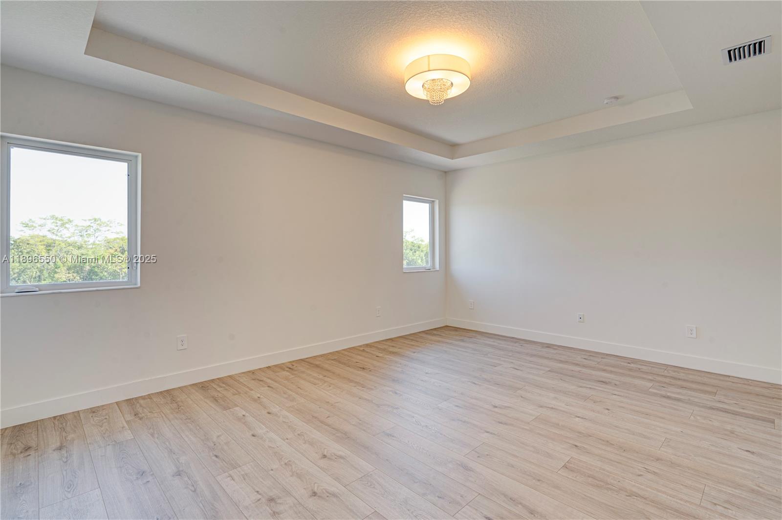 4390 Southwest 122nd Terrace Davie, FL 33330 - Photo 54 of 65 an empty room with wooden floor and windows