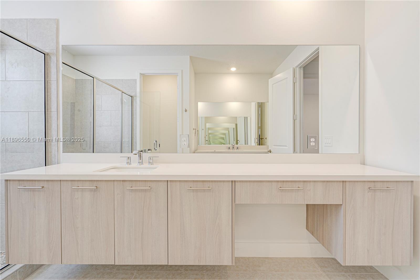 4390 Southwest 122nd Terrace Davie, FL 33330 - Photo 59 of 65 a bathroom with a sink and a mirror