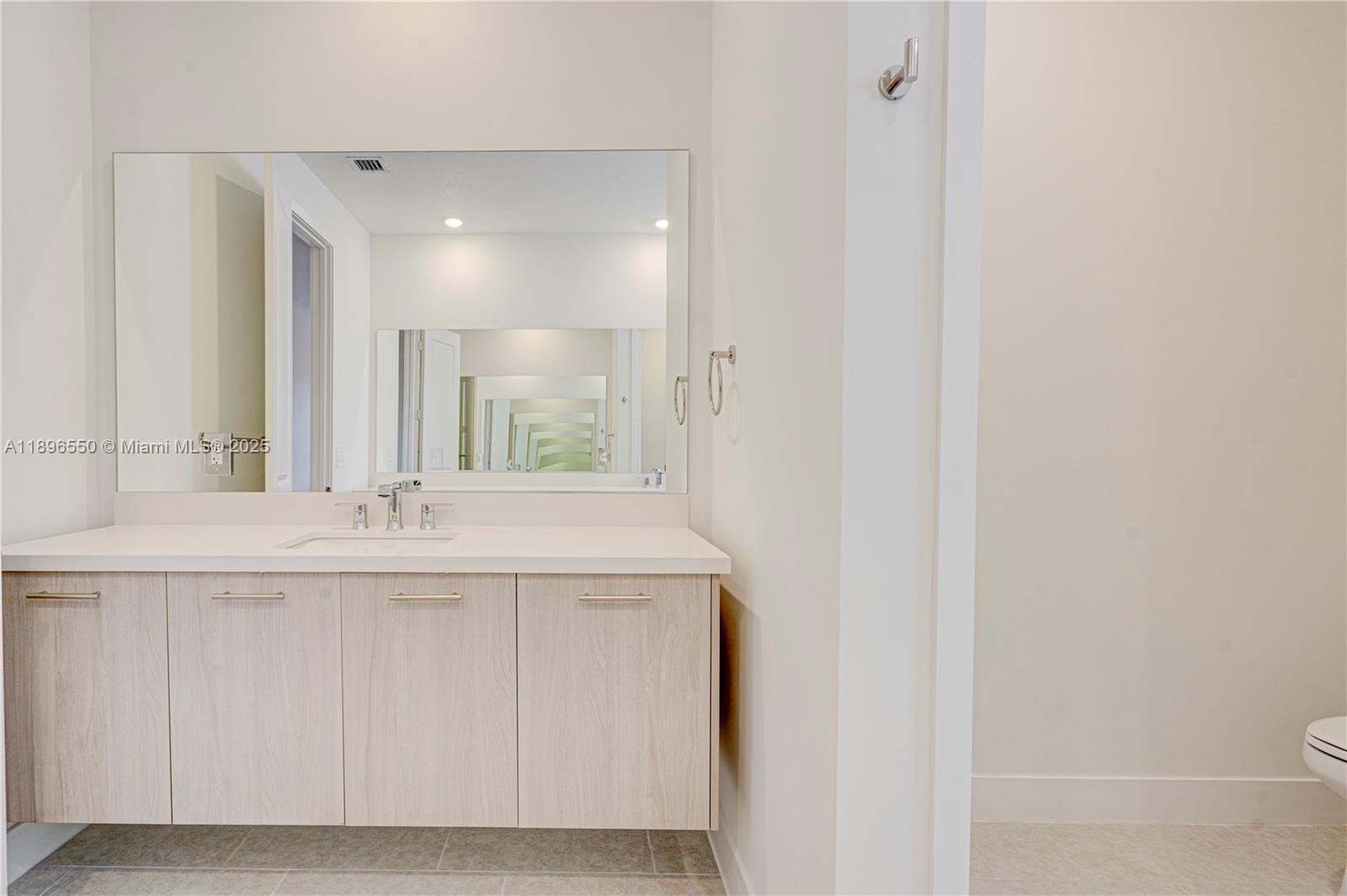 4390 Southwest 122nd Terrace Davie, FL 33330 - Photo 60 of 65 a bathroom with a granite countertop sink and a mirror