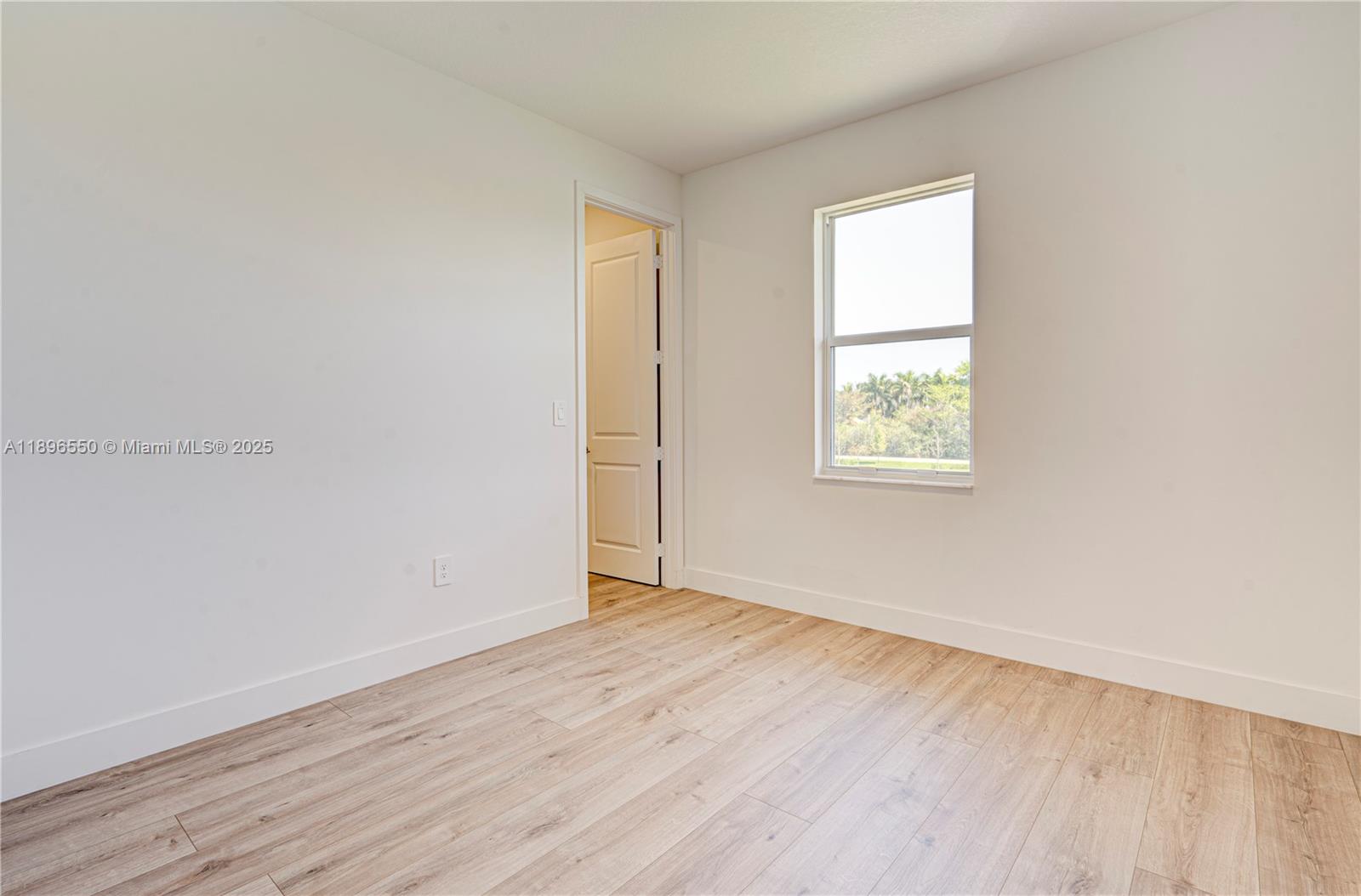 4390 Southwest 122nd Terrace Davie, FL 33330 - Photo 61 of 65 an empty room with wooden floor and windows
