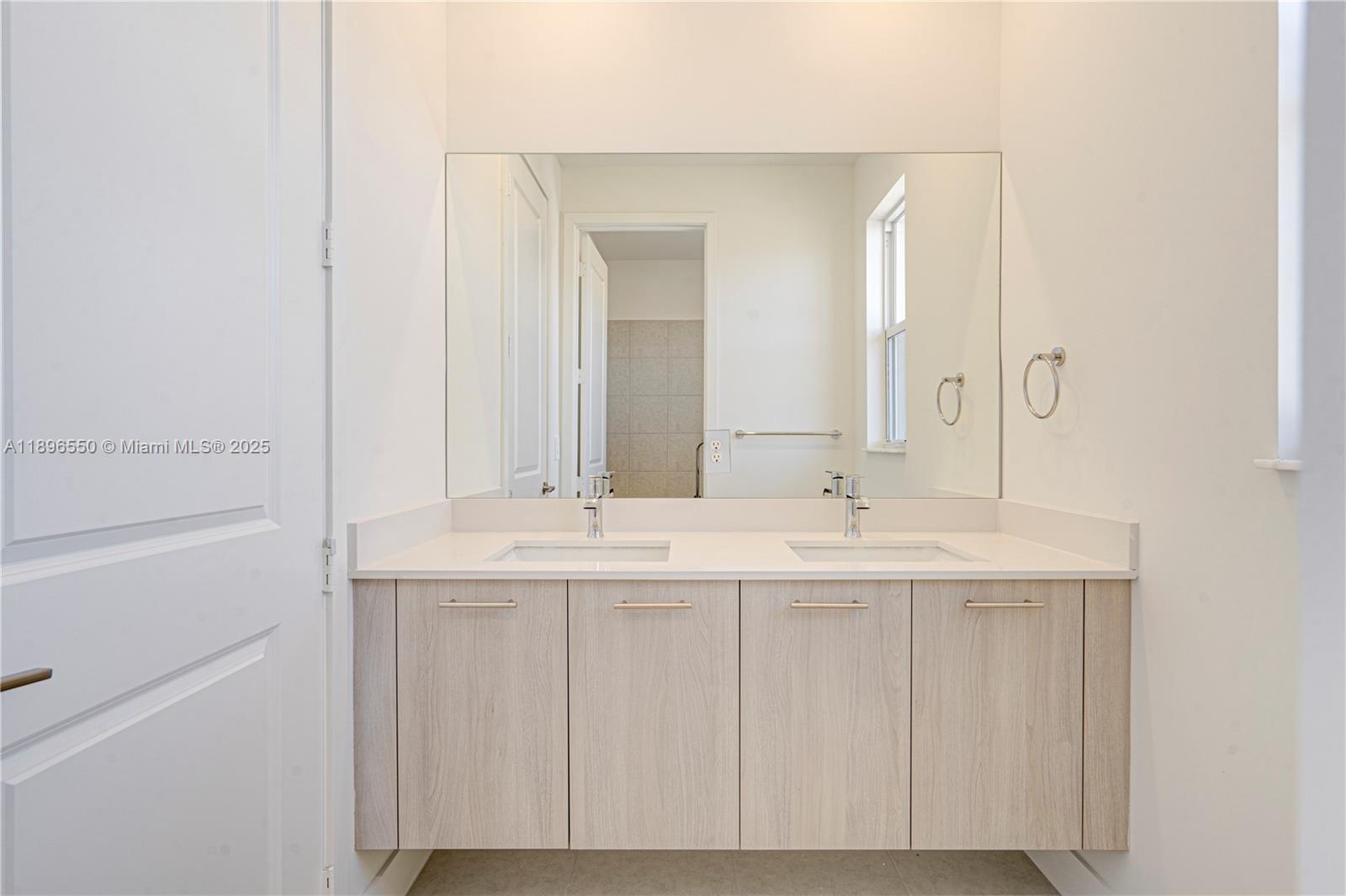 4390 Southwest 122nd Terrace Davie, FL 33330 - Photo 63 of 65 a bathroom with a sink and a mirror