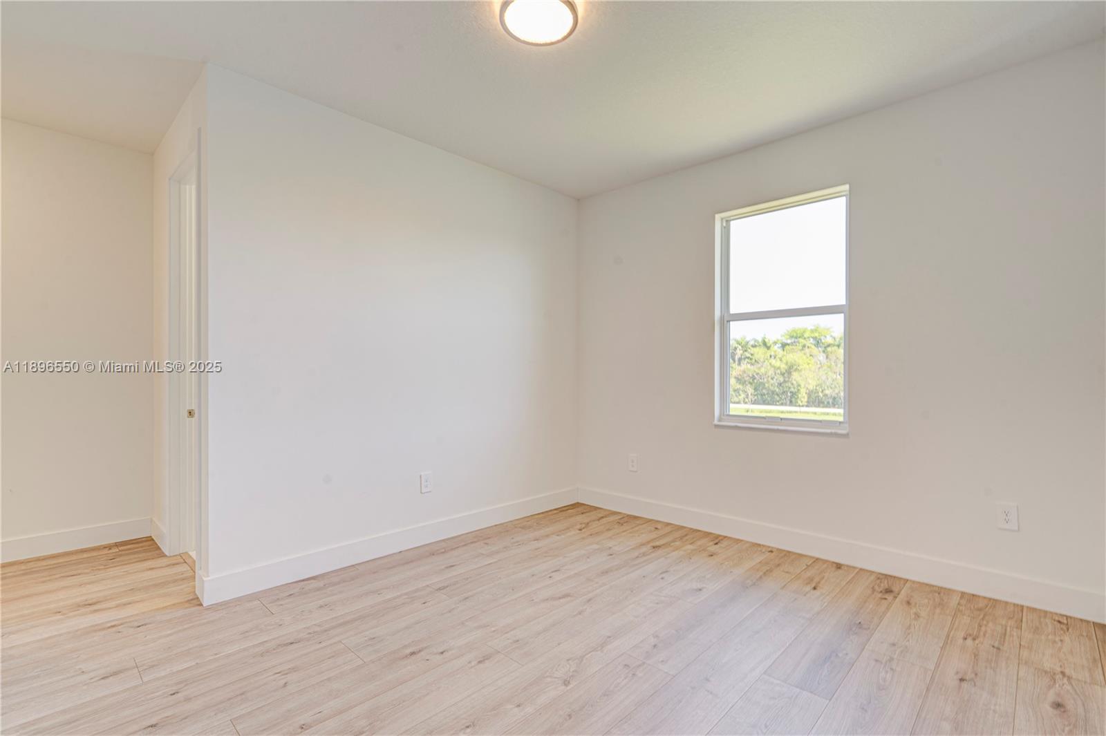 4390 Southwest 122nd Terrace Davie, FL 33330 - Photo 65 of 65 an empty room with wooden floor and windows