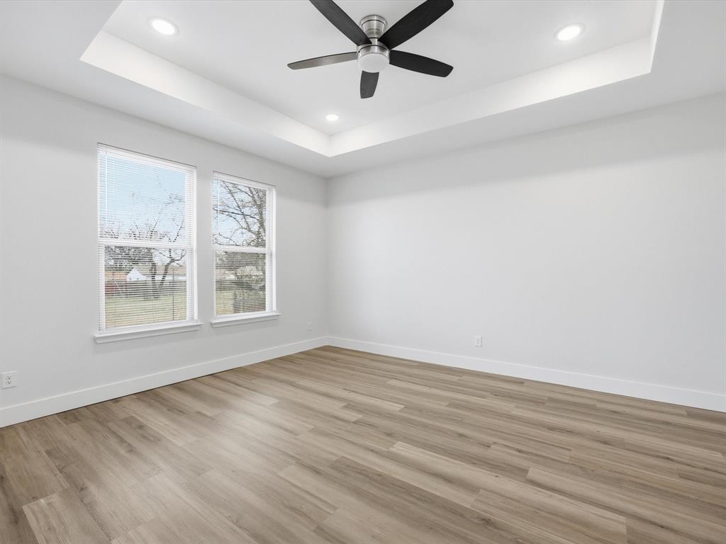 108 Couch Street Italy, TX 76651 - Photo 11 of 23 wooden floor in an empty room with a window