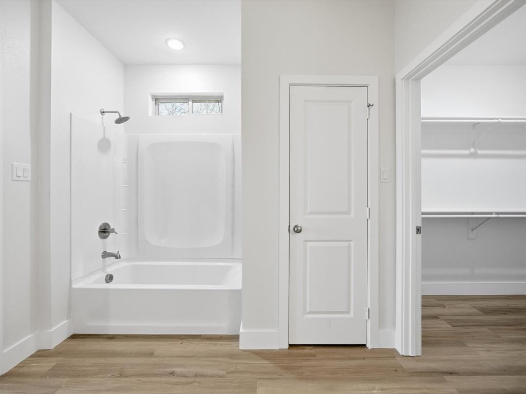 108 Couch Street Italy, TX 76651 - Photo 13 of 23 a bathroom with a bathtub and a shower