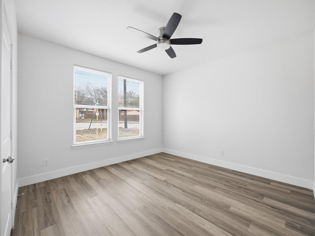 108 Couch Street Italy, TX 76651 - Photo 14 of 23 a view of empty room with wooden floor and fan