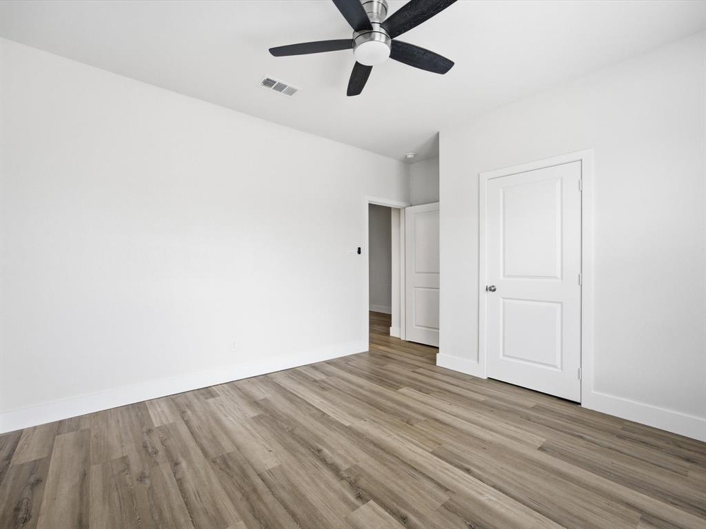 108 Couch Street Italy, TX 76651 - Photo 15 of 23 a view of a room with wooden floor and white walls