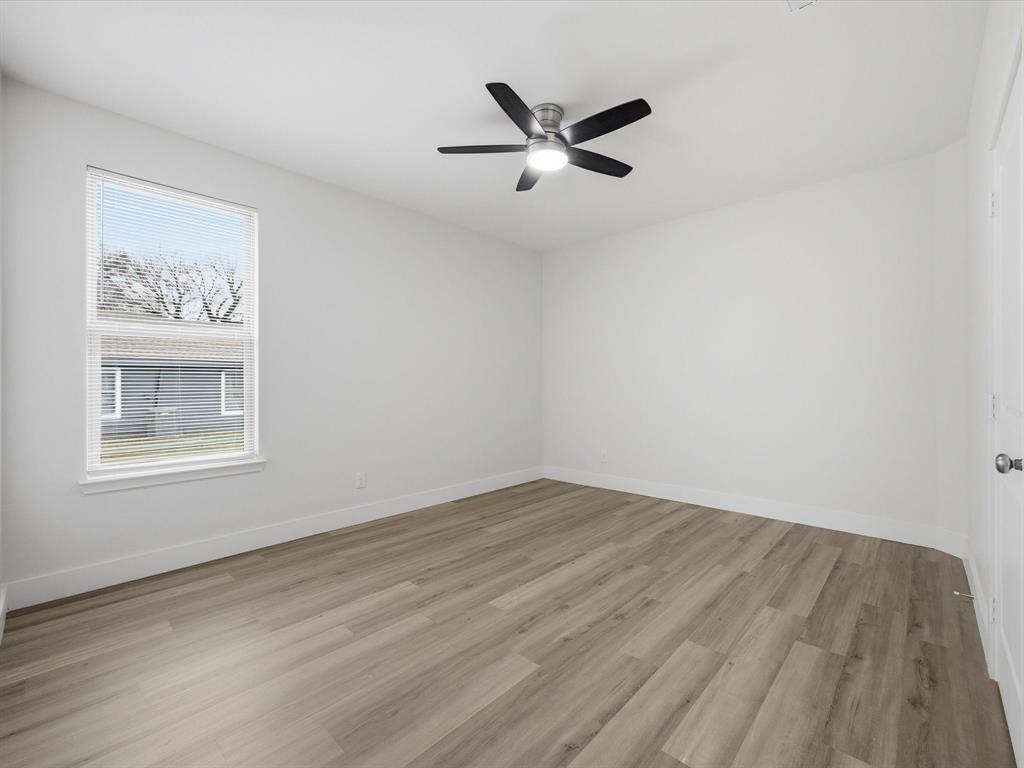 108 Couch Street Italy, TX 76651 - Photo 16 of 23 a view of an empty room and wooden floor