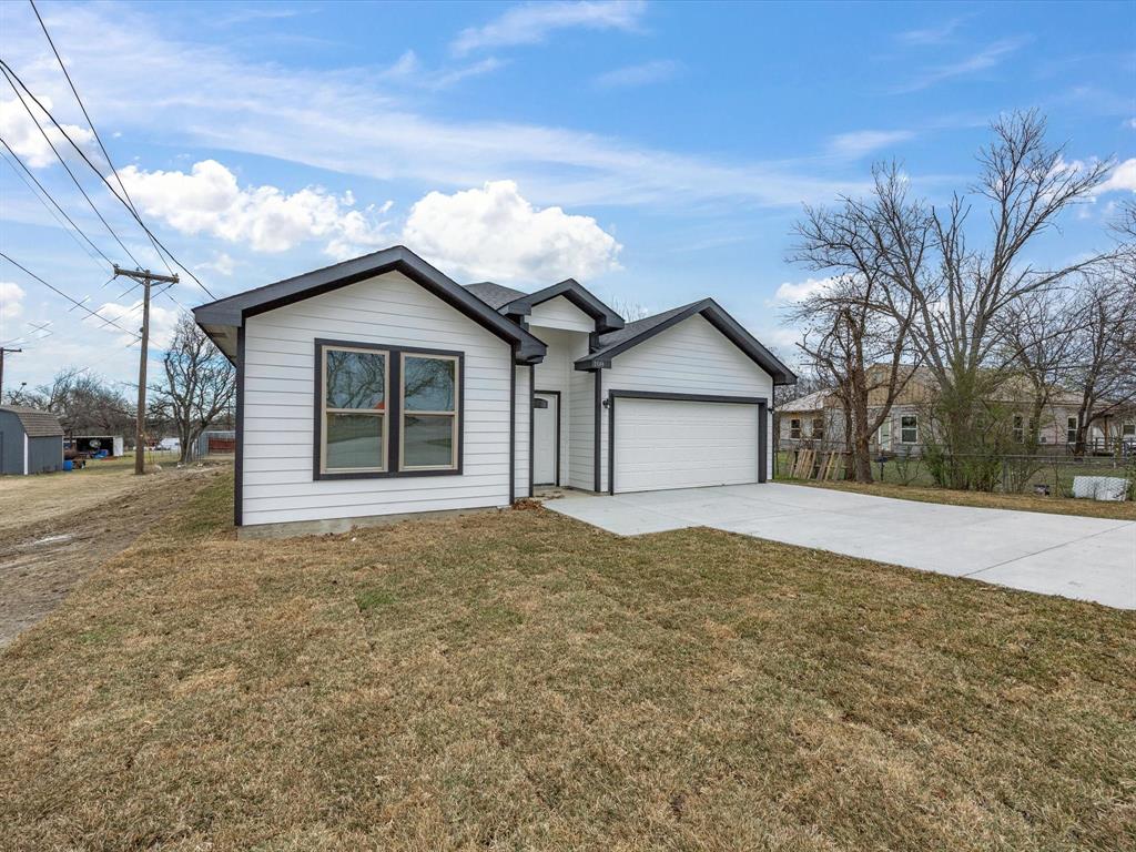 108 Couch Street Italy, TX 76651 - Photo 2 of 23 a view of a house with a yard and garage