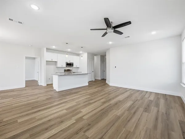 a view of kitchen with wooden floor and window