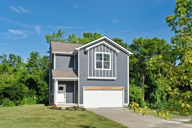 an aerial view of residential houses with outdoor space and city view