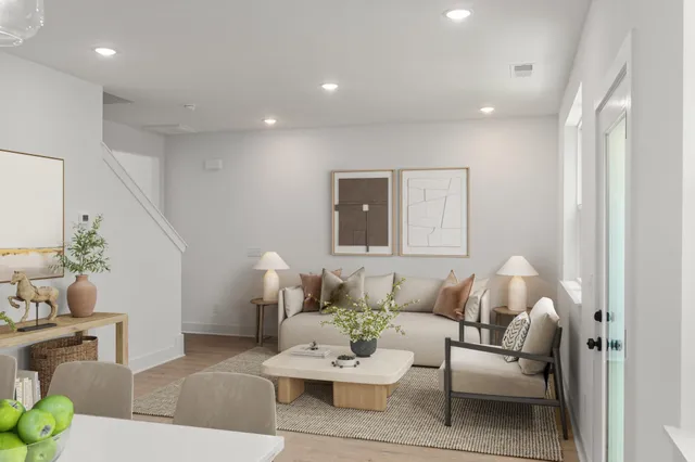 a living room with furniture and a potted plant