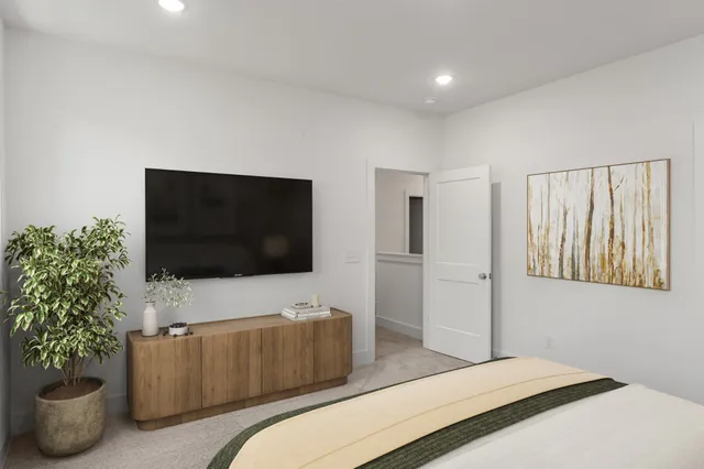 a bedroom with a bed and a flat screen tv