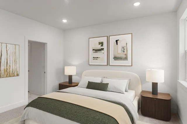 a bedroom with a bed and a lamp