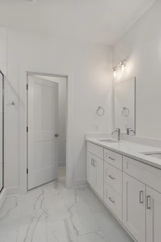 a spacious bathroom with a granite countertop sink a mirror and a