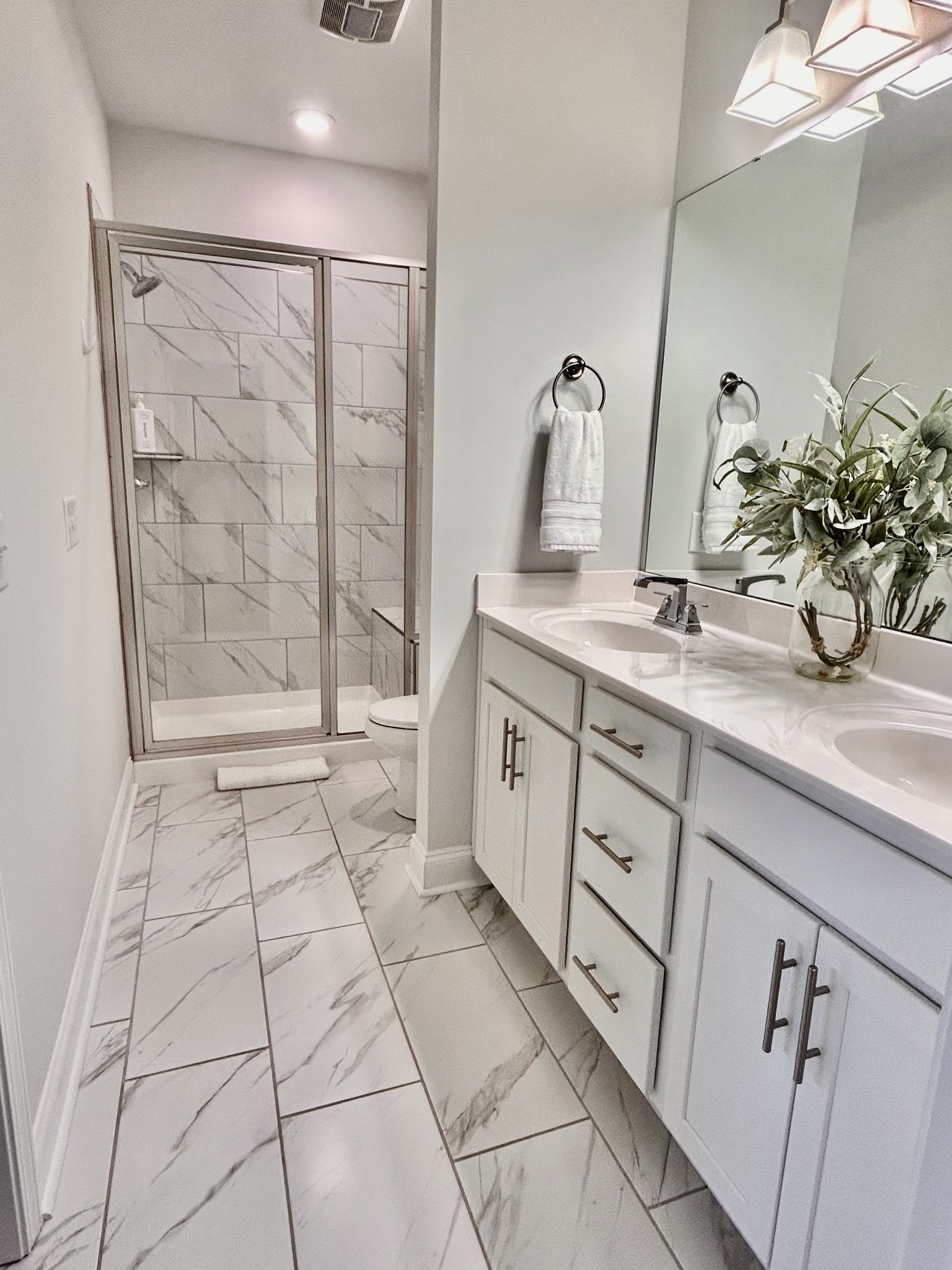 1000 June Wilde Ridge Spring Hill, TN 37174 - Photo 16 of 37 a bathroom with a shower sink and mirror