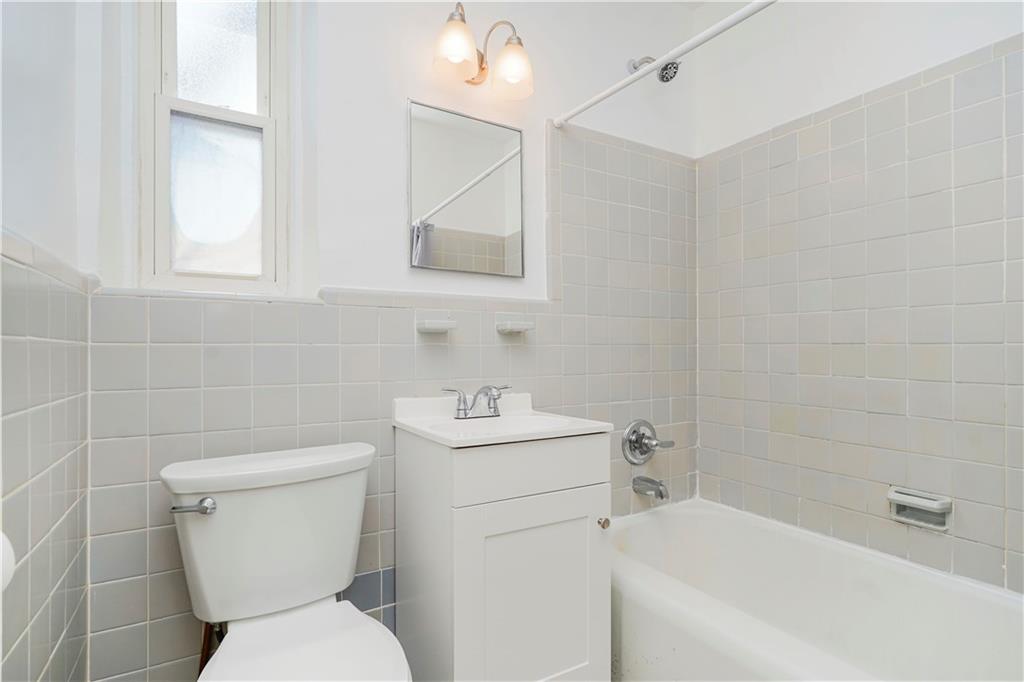 9430 Ridge Boulevard, Unit 6F Brooklyn, NY 11209 - Photo 5 of 15 a white toilet sitting next to a white sink
